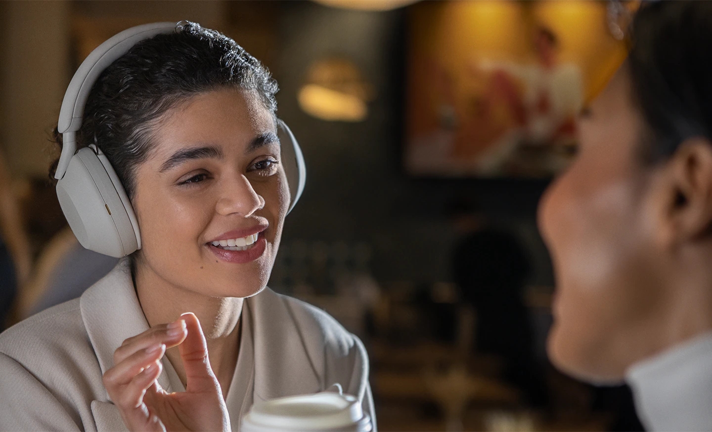 Sony WH-1000XM5 headphones on woman