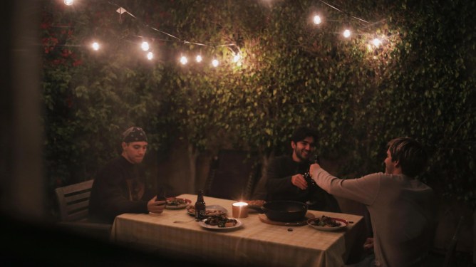 3 men sitting at a dinner table