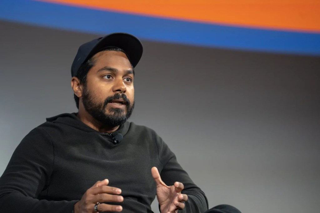 A picture of Raj Gokal, co-founder of Solana, talking at an event.