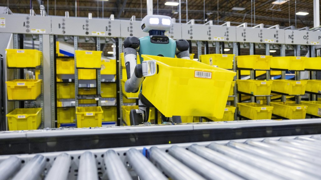 Amazon Agility Robotics Digit handling a tub in a warehouse