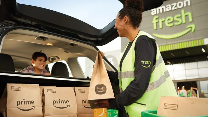 Amazon Fresh worker loading grocery bags into car